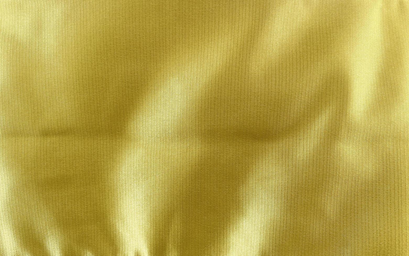 golden cloth  fabric texture used as background. Empty golden cloth fabric background of soft and smooth textile material. There is space for text. photo