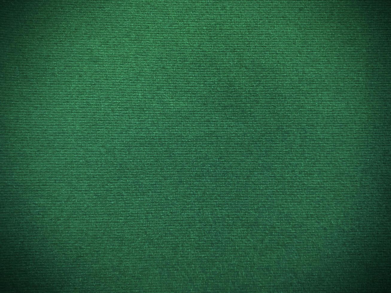 Dark green velvet fabric texture used as background. Empty green fabric background of soft and smooth textile material. There is space for text. photo