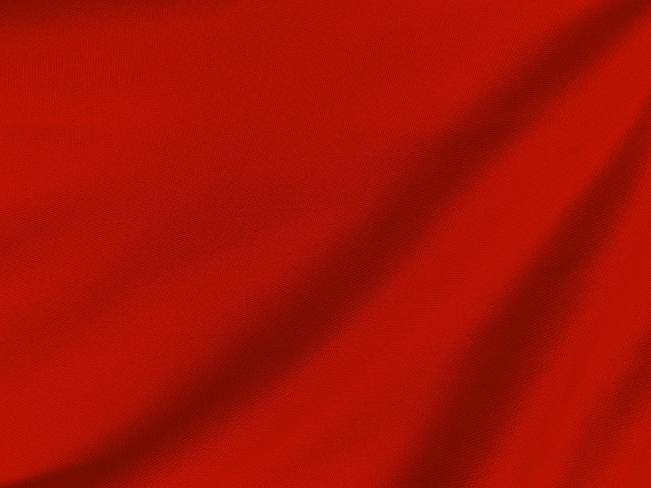 textura de tela de algodón rojo utilizada como fondo. fondo de tela roja vacía de material textil suave y liso. hay espacio para el texto.. foto