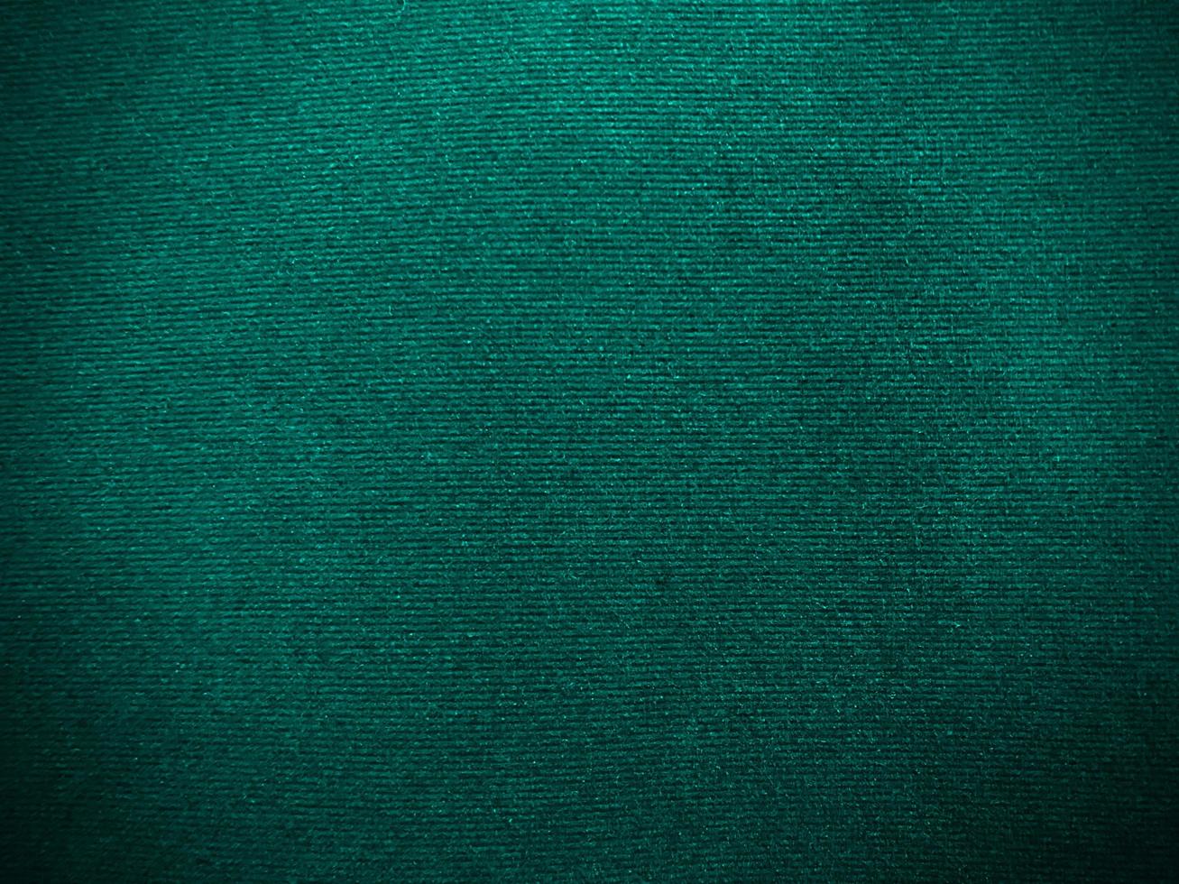 Dark green new velvet fabric texture used as background. Empty green fabric background of soft and smooth textile material. There is space for text.. photo
