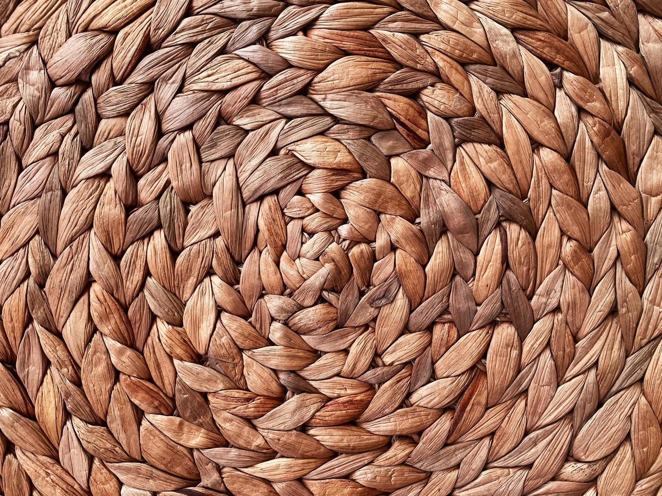 Round braided natural straw table mat texture as a background. Full frame of tightly woven straw pattern.with space for text, for a background. photo
