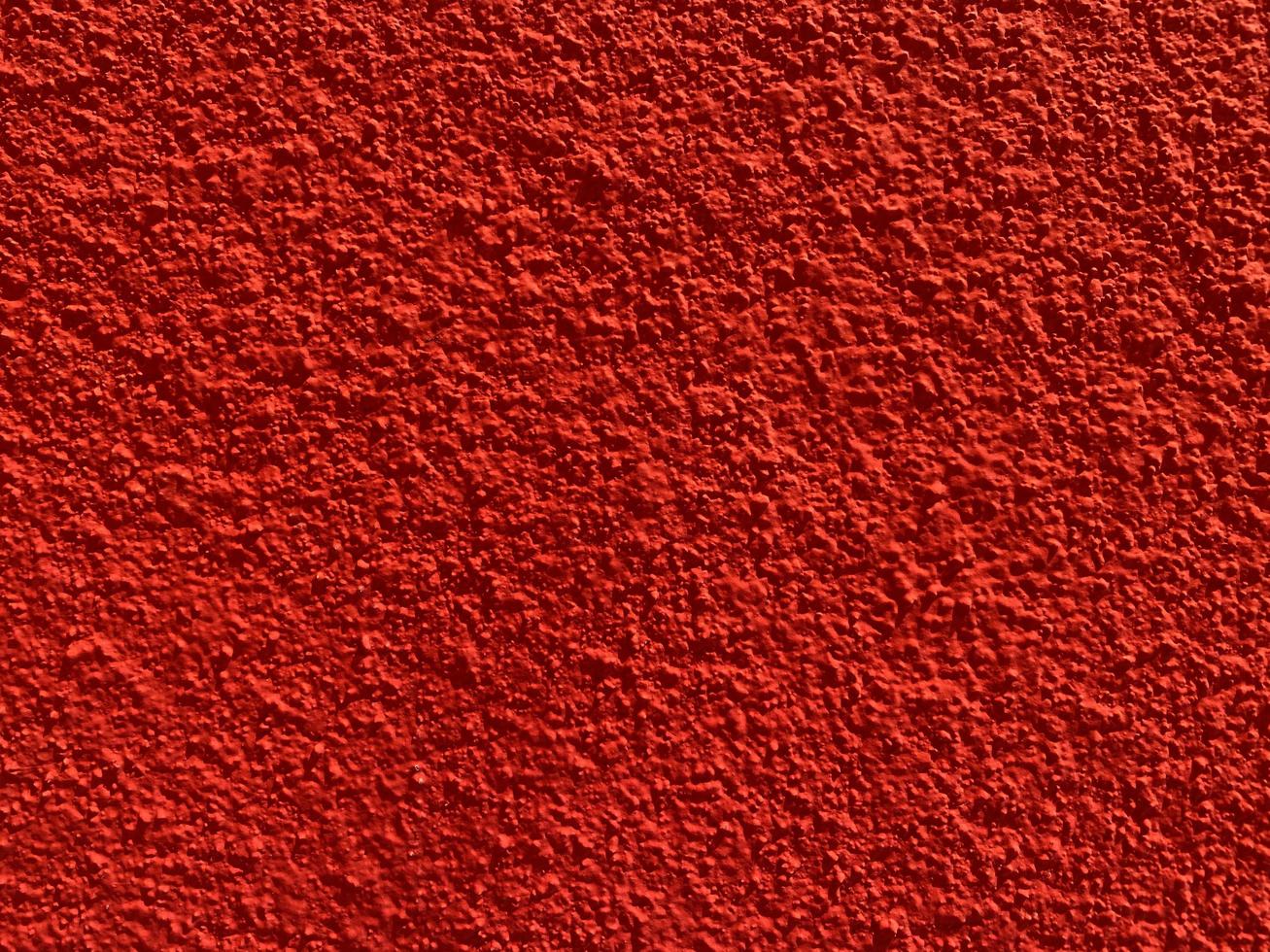 textura sin fisuras de la antigua muralla de cemento rojo una superficie rugosa, con espacio para texto, para un fondo. foto