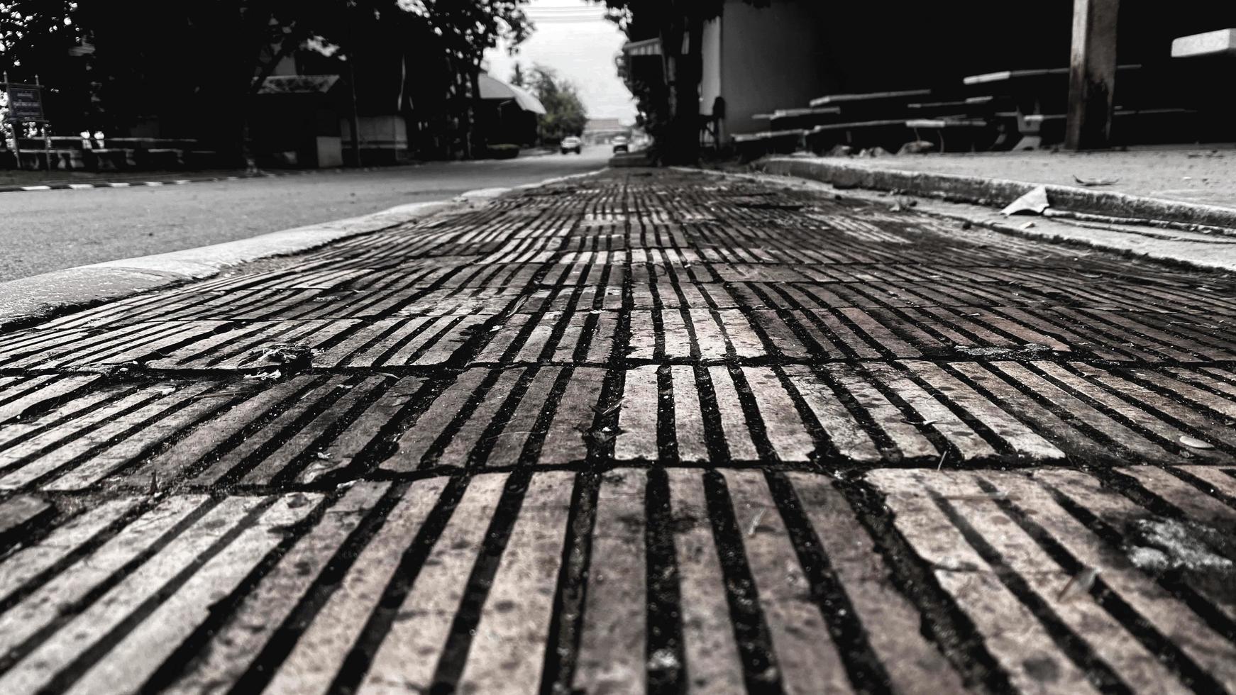 Monotone  Brick Stone on The Ground for Street Road. Sidewalk, Driveway, Pavers, Pavement in Vintage Design Flooring Square Pattern Texture Background photo