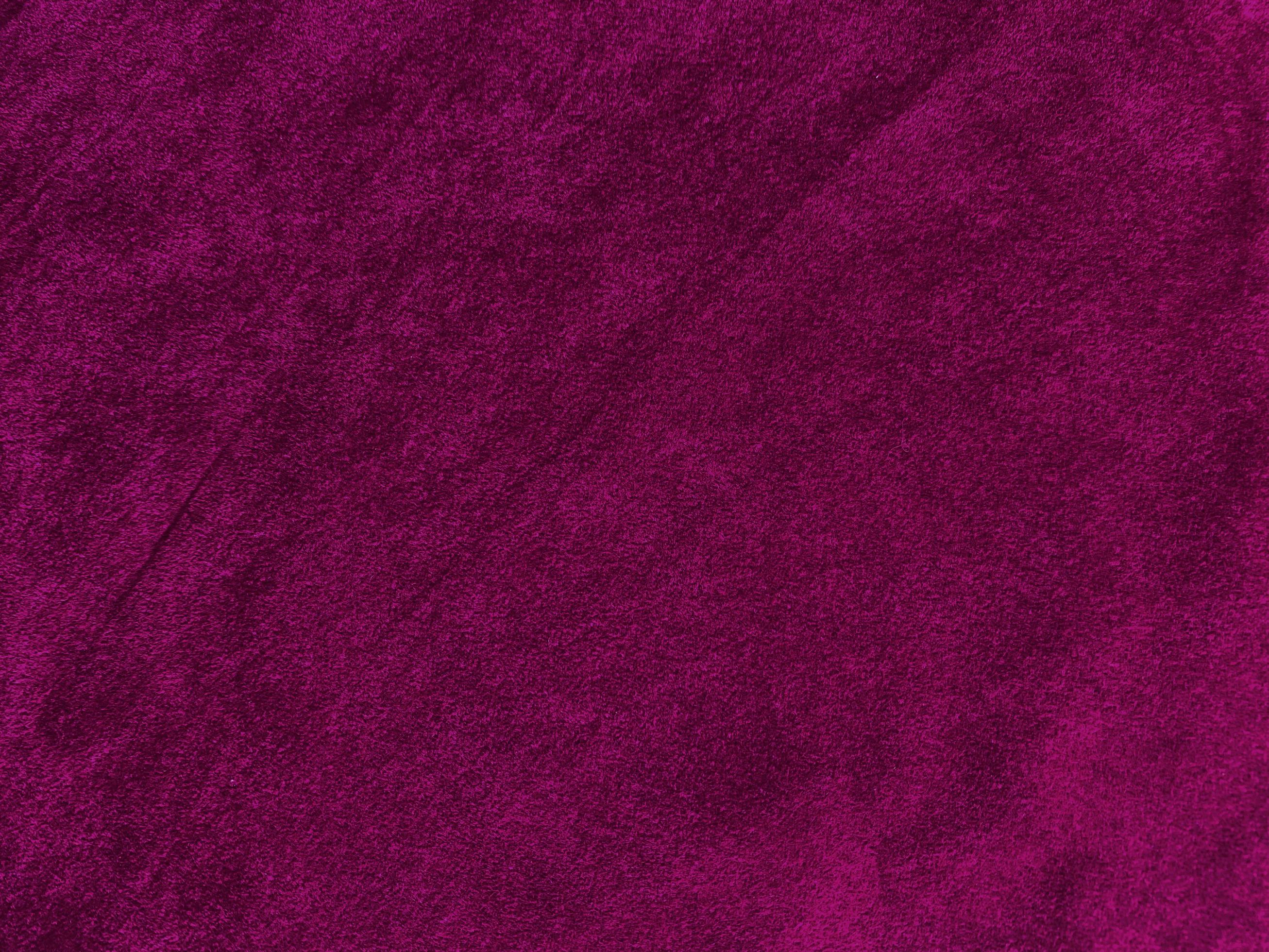 Purple magenta velvet fabric texture used as background. Empty purple