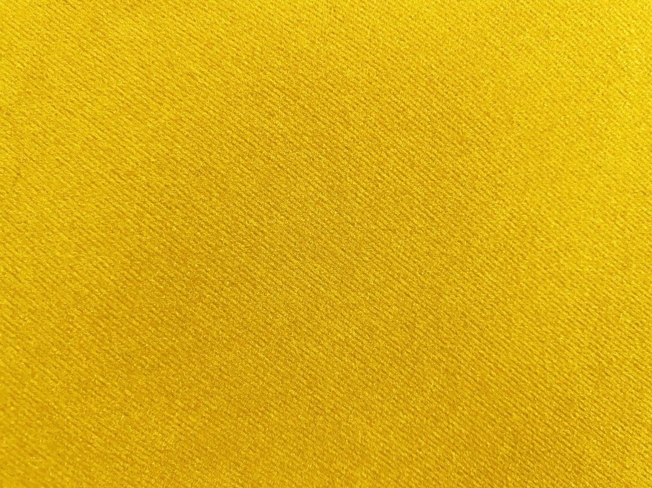 Yellow velvet fabric texture used as background. Empty yellow fabric