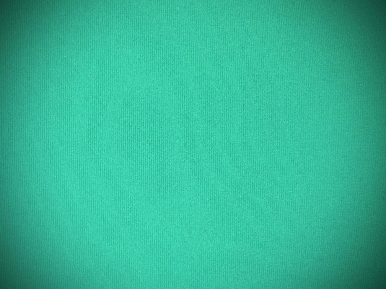 Mint green velvet fabric texture used as background. Empty green fabric