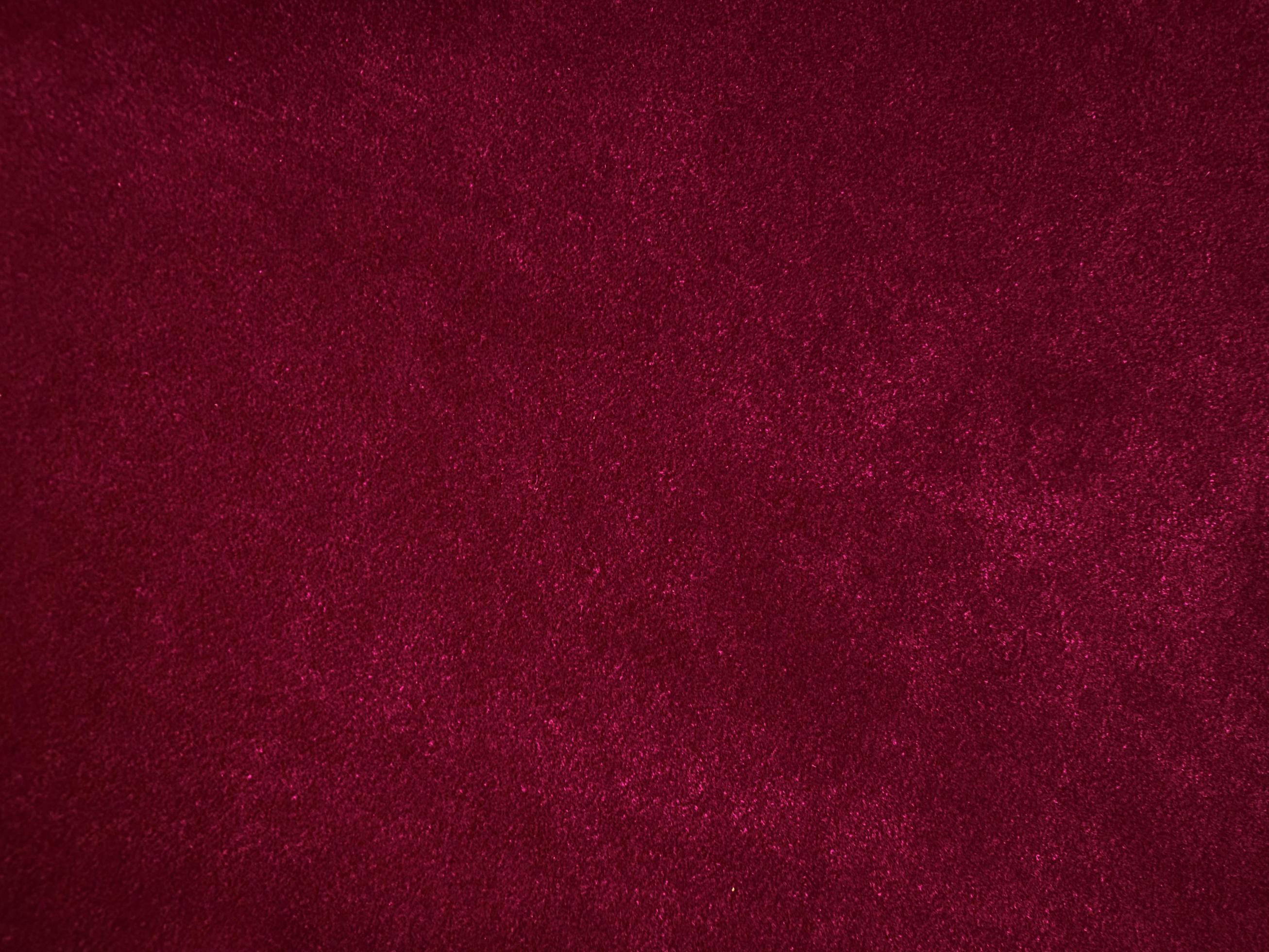 Purple magenta velvet fabric texture used as background. Empty purple
