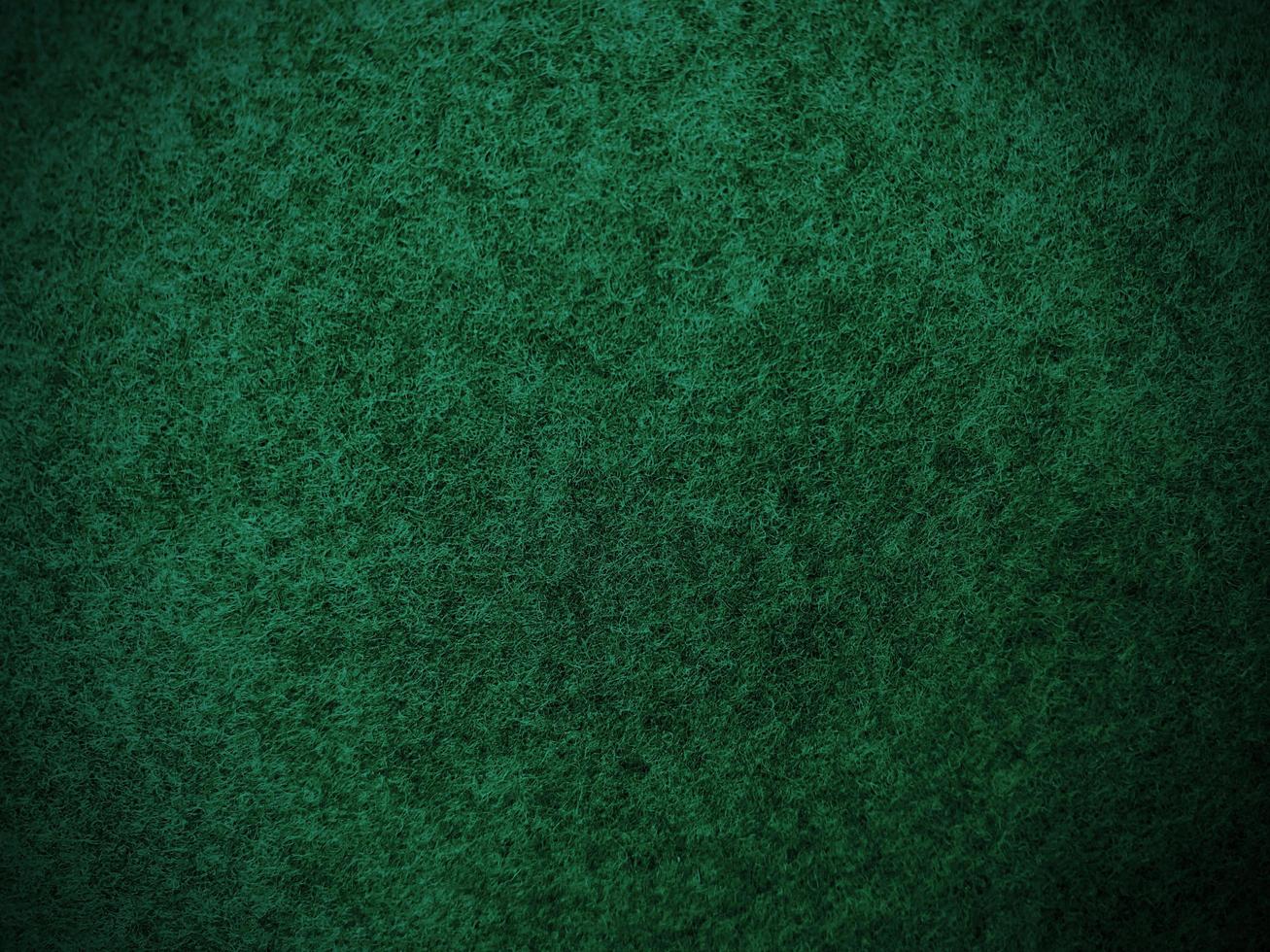 Felt dark green soft rough textile material background texture close up,poker table,tennis ball,table cloth. Empty green fabric background. photo