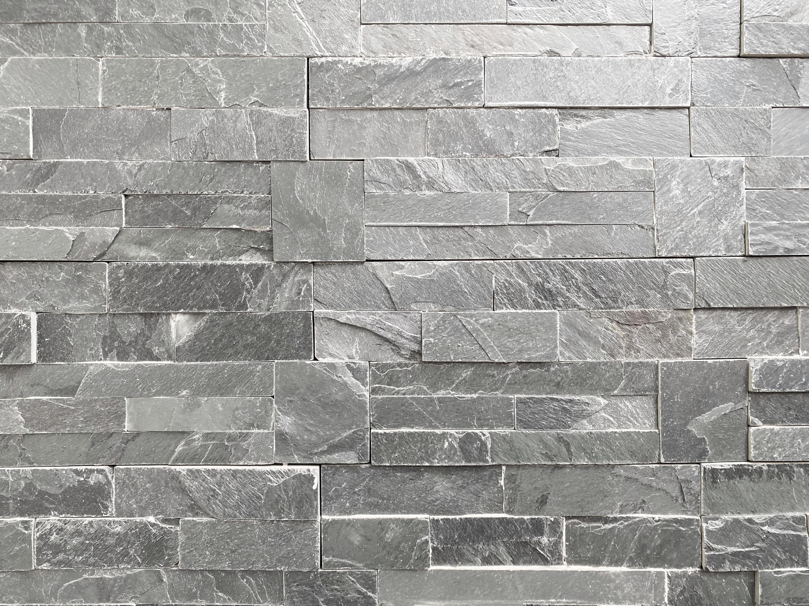Seamless texture of white grey brick stone wall a rough surface, with