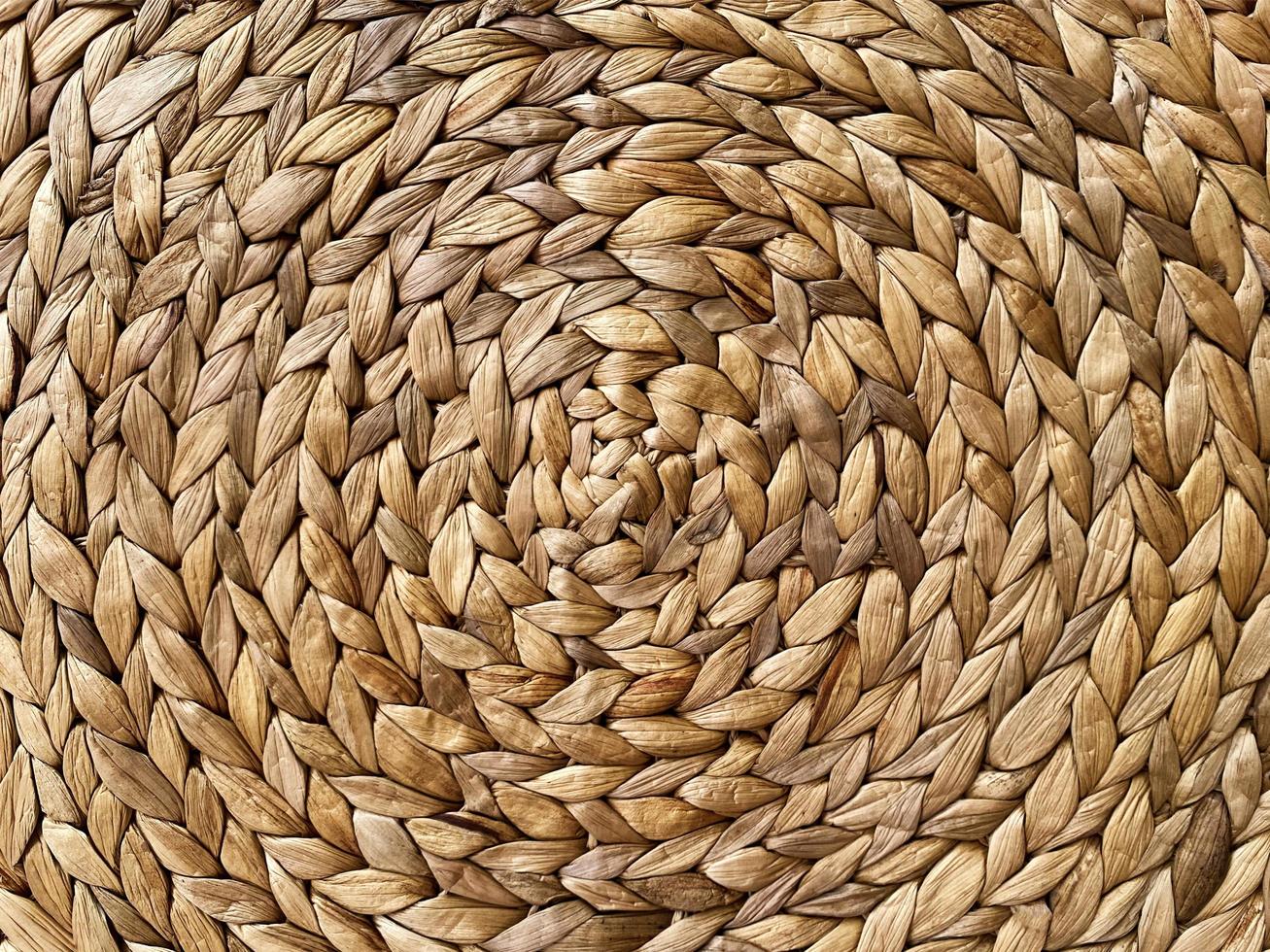 Round braided natural straw table mat texture as a background. Full frame of tightly woven straw pattern.with space for text, for a background. photo