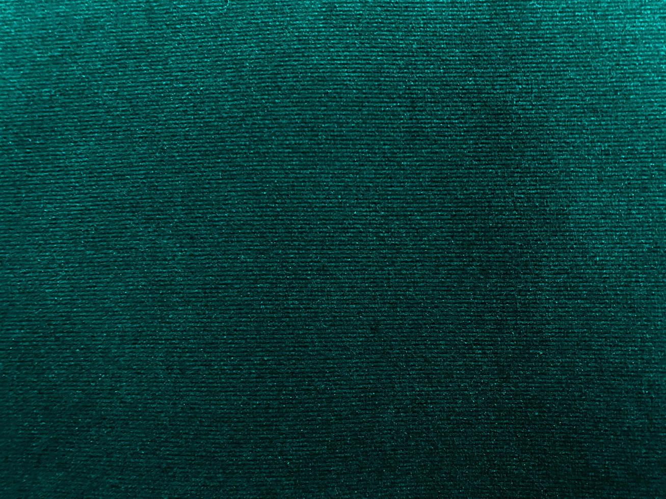 Dark green old velvet fabric texture used as background. Empty green fabric background of soft and smooth textile material. There is space for text... photo