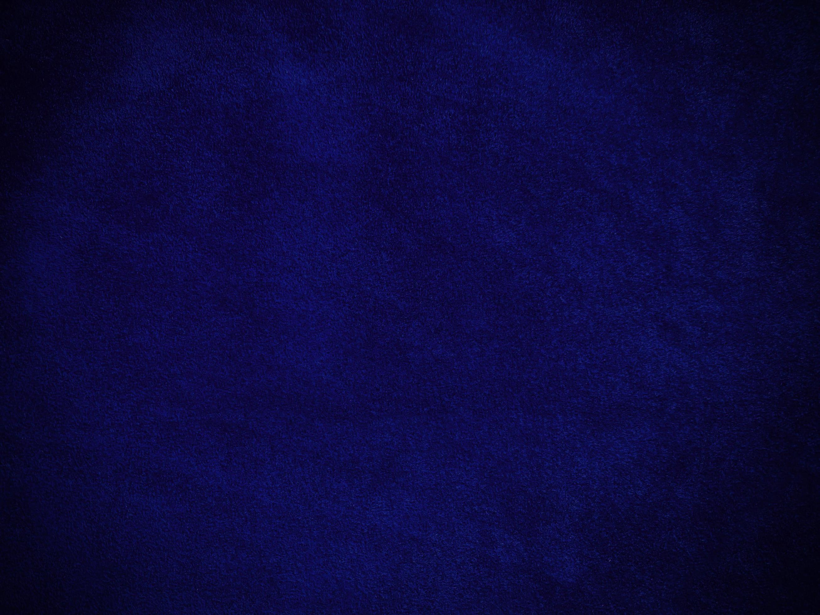 Blue velvet fabric texture used as background. Empty blue fabric