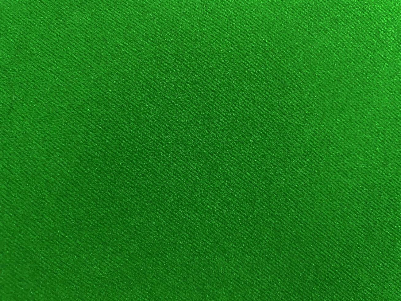 Green old velvet fabric texture used as background. Empty green fabric