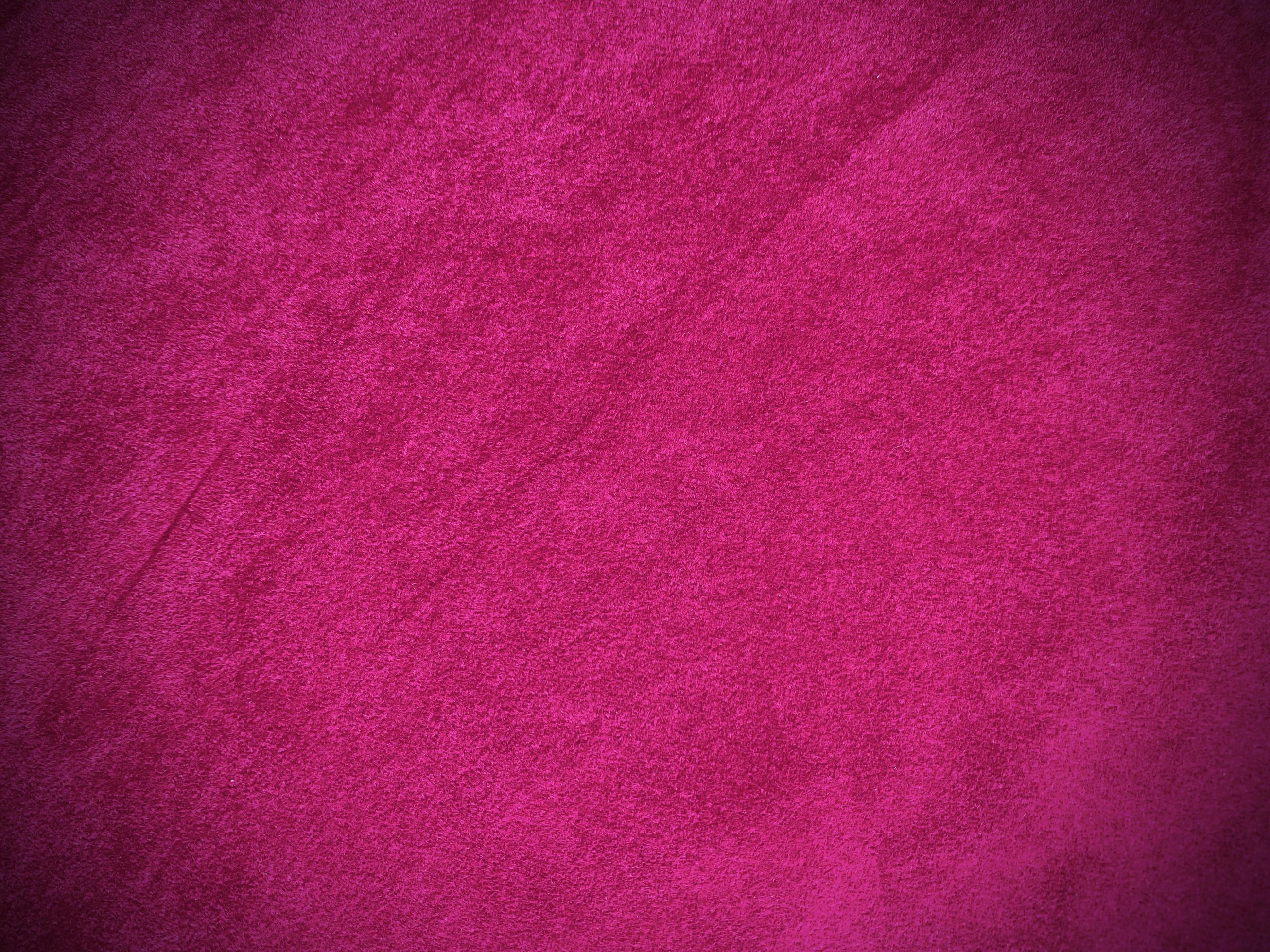 Pink velvet fabric texture used as background. Empty pink fabric