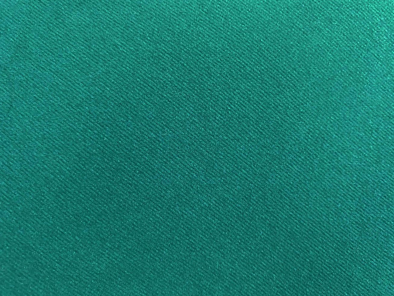 Dark green old velvet fabric texture used as background. Empty green fabric background of soft and smooth textile material. There is space for text. photo