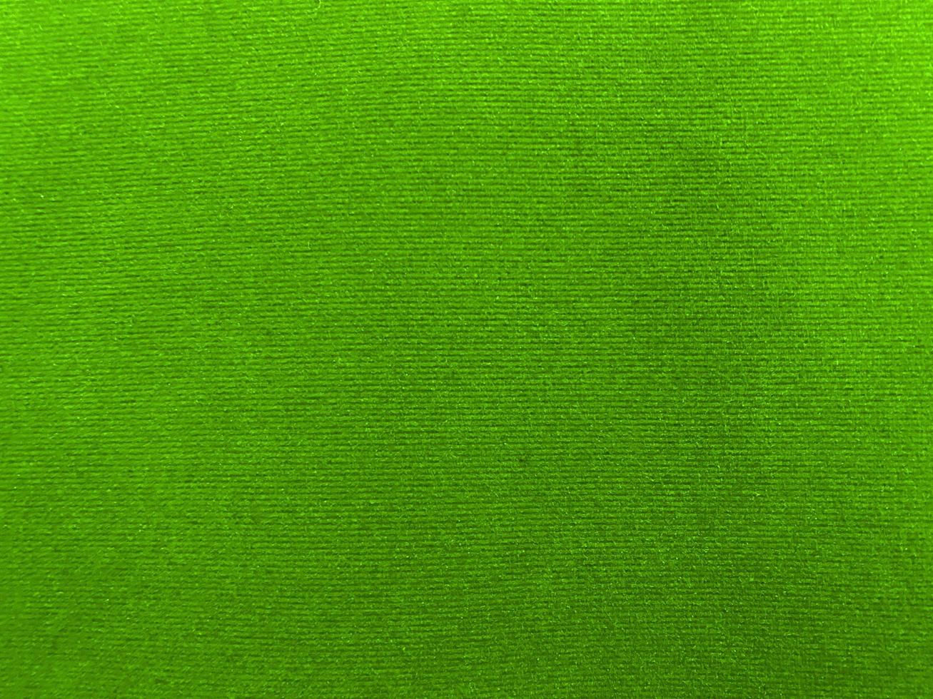 Green velvet fabric texture used as background. Empty green fabric