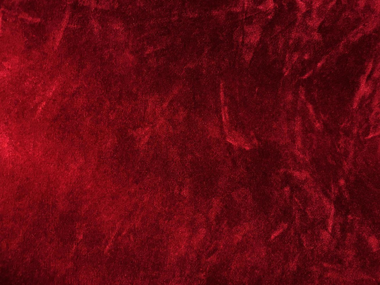 Dark red velvet fabric texture used as background. Empty dark red