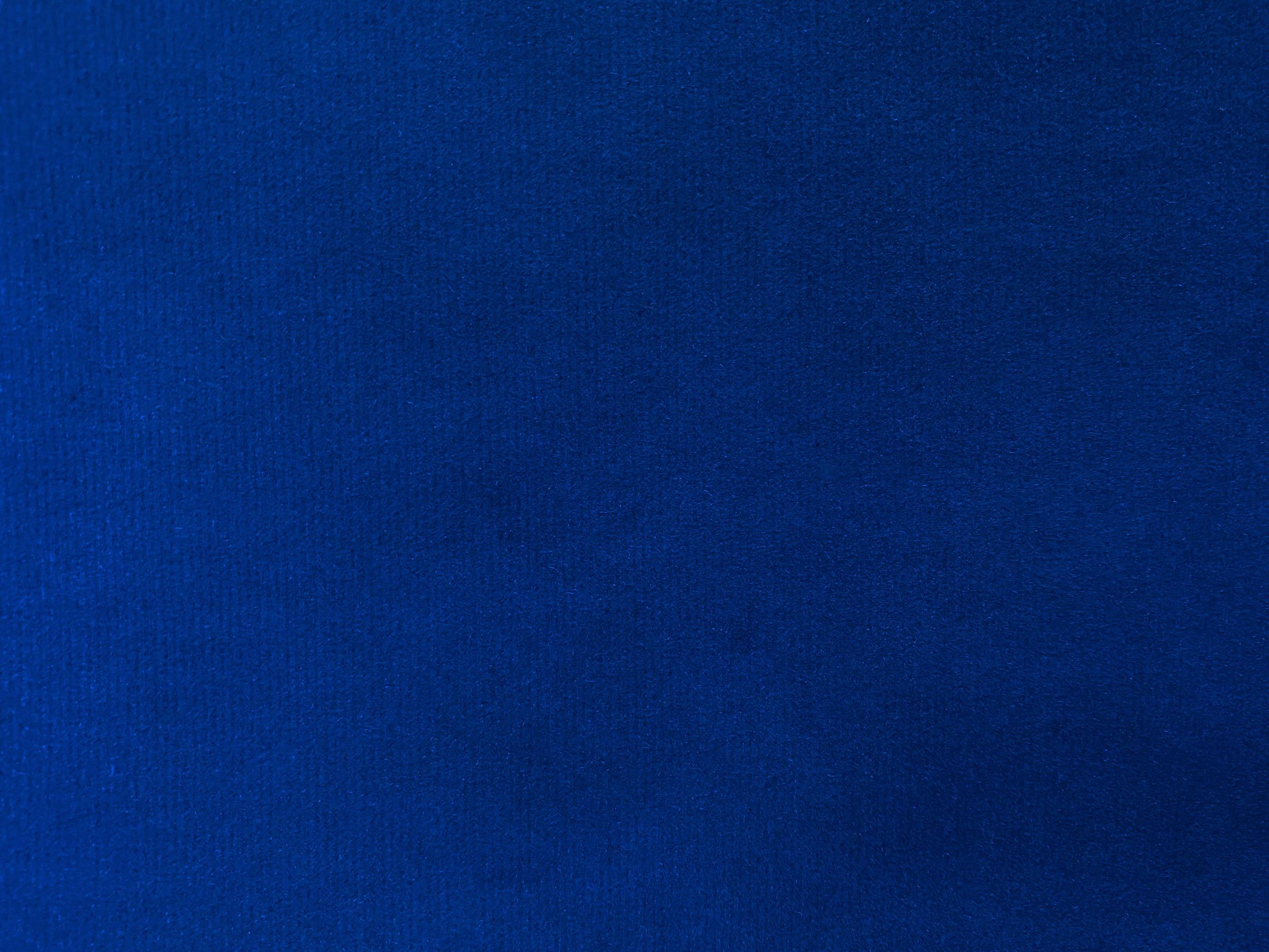 Blue velvet fabric texture used as background. Empty blue fabric