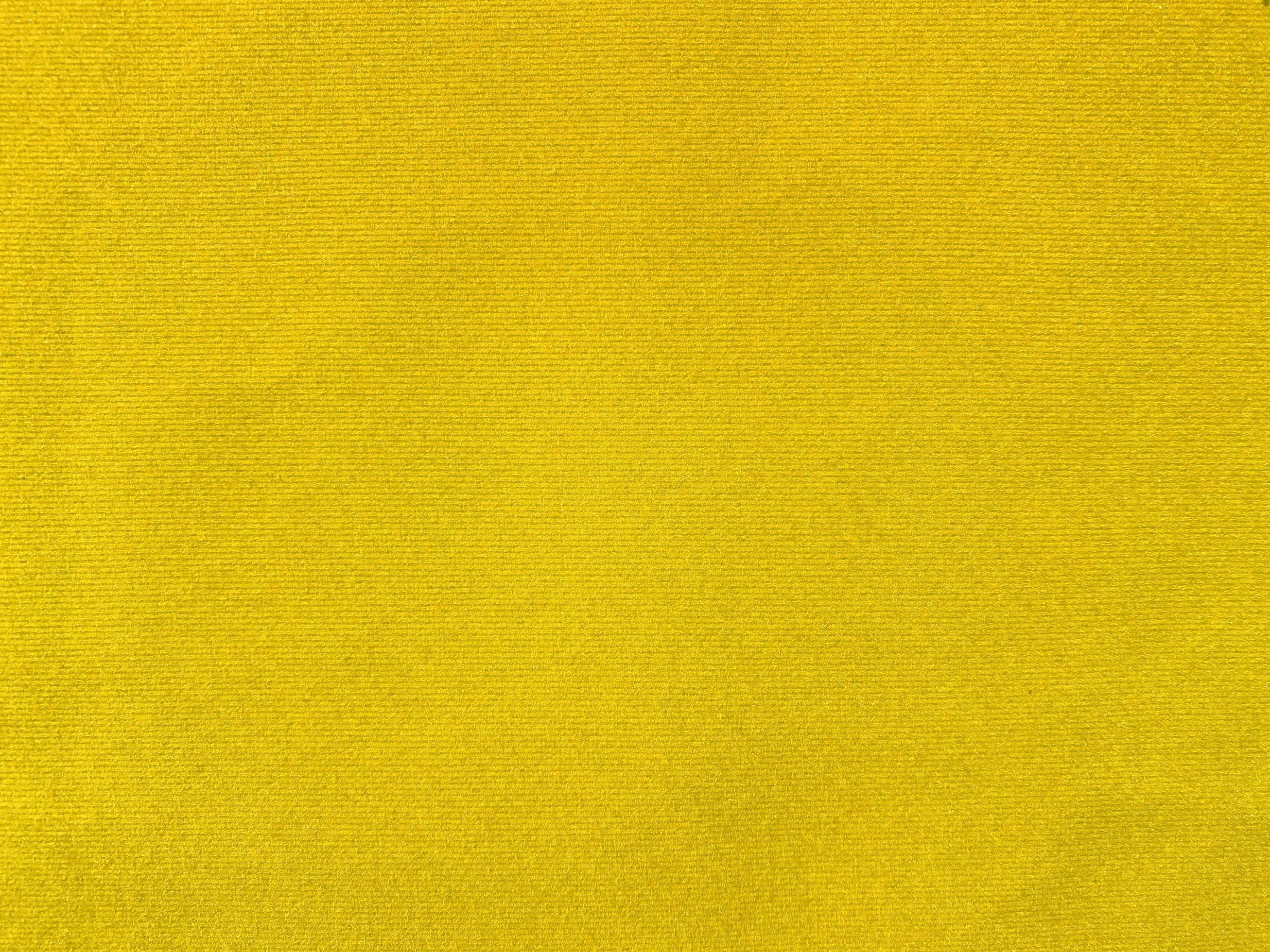 Yellow velvet fabric texture used as background. Empty yellow fabric