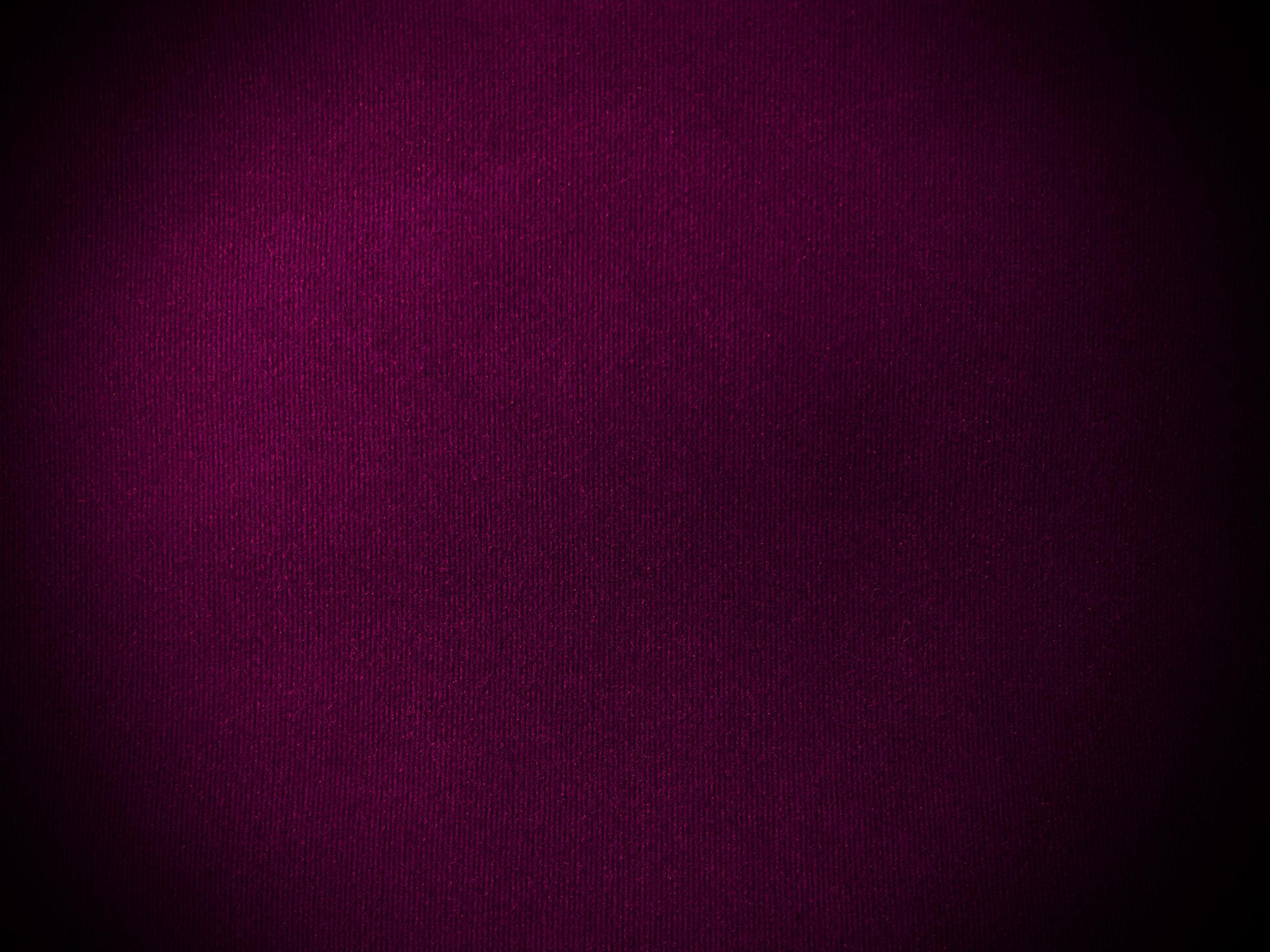 Dark magenta velvet fabric texture used as background. Empty