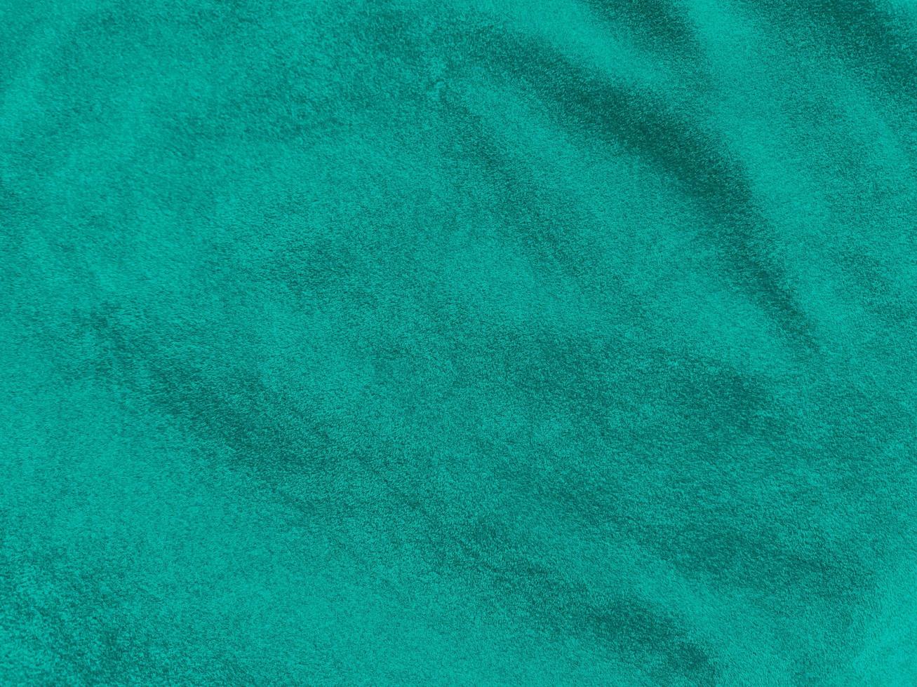Dark green old velvet fabric texture used as background. Empty green fabric background of soft and smooth textile material. There is space for text... photo