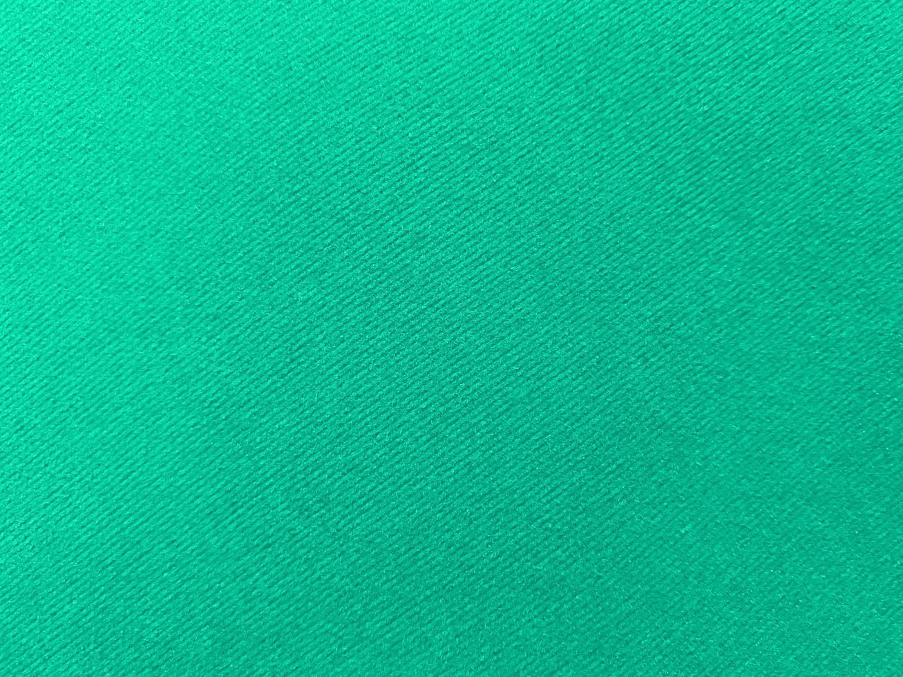 Dark green old velvet fabric texture used as background. Empty green fabric background of soft and smooth textile material. There is space for text.. photo