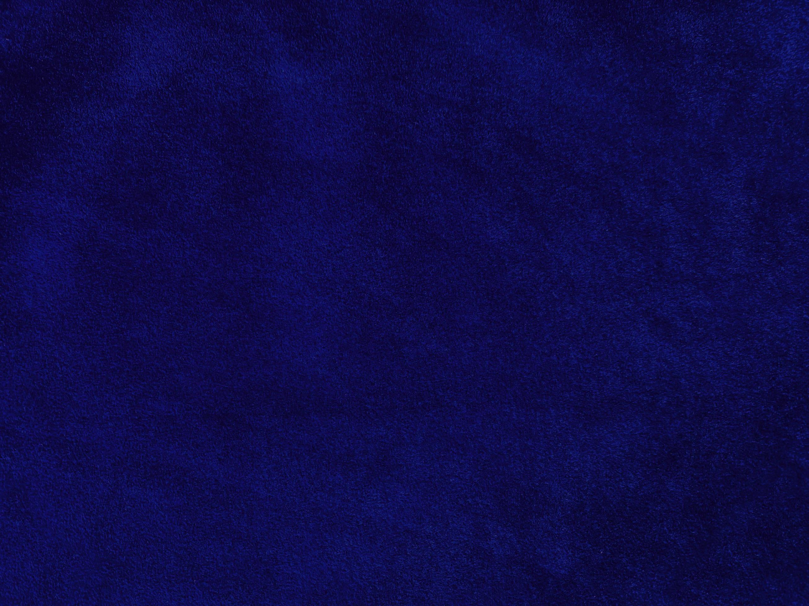 Blue velvet fabric texture used as background. Empty blue fabric