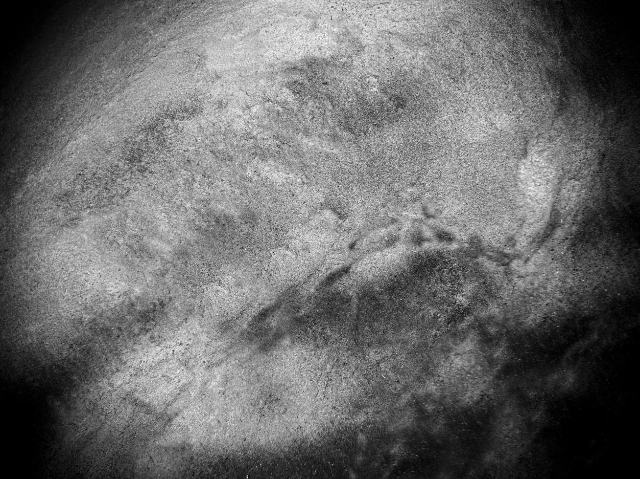 Surface of the dark black stone texture rough, gray-white tone. Use this for wallpaper or background image. There is a blank space for text photo