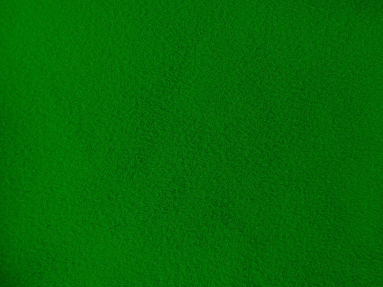 Felt green soft rough textile material background texture close up,poker table,tennis ball,table cloth. Empty green fabric background. photo