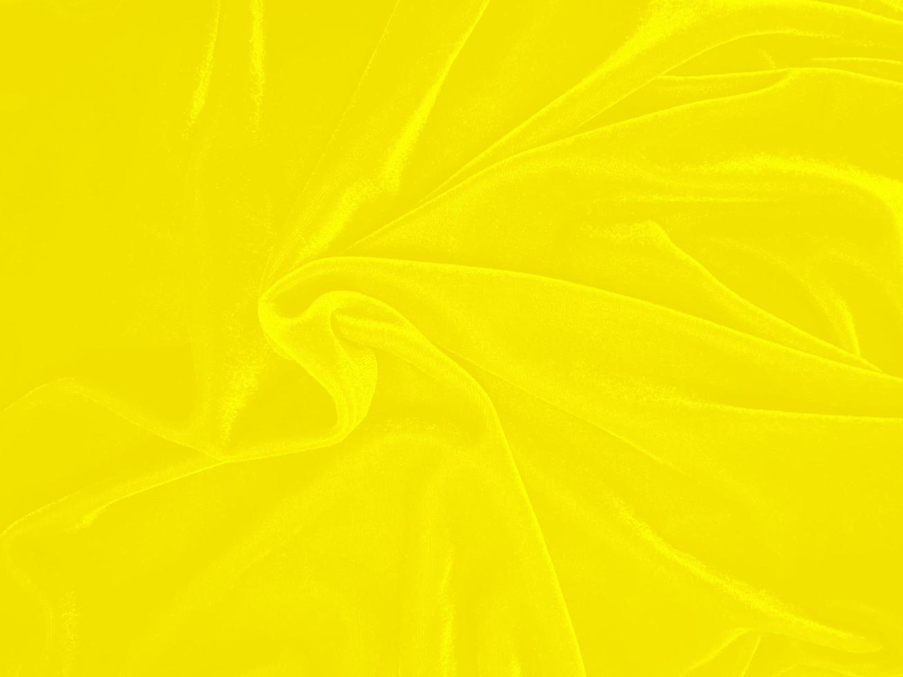 Yellow velvet fabric texture used as background. Empty yellow fabric