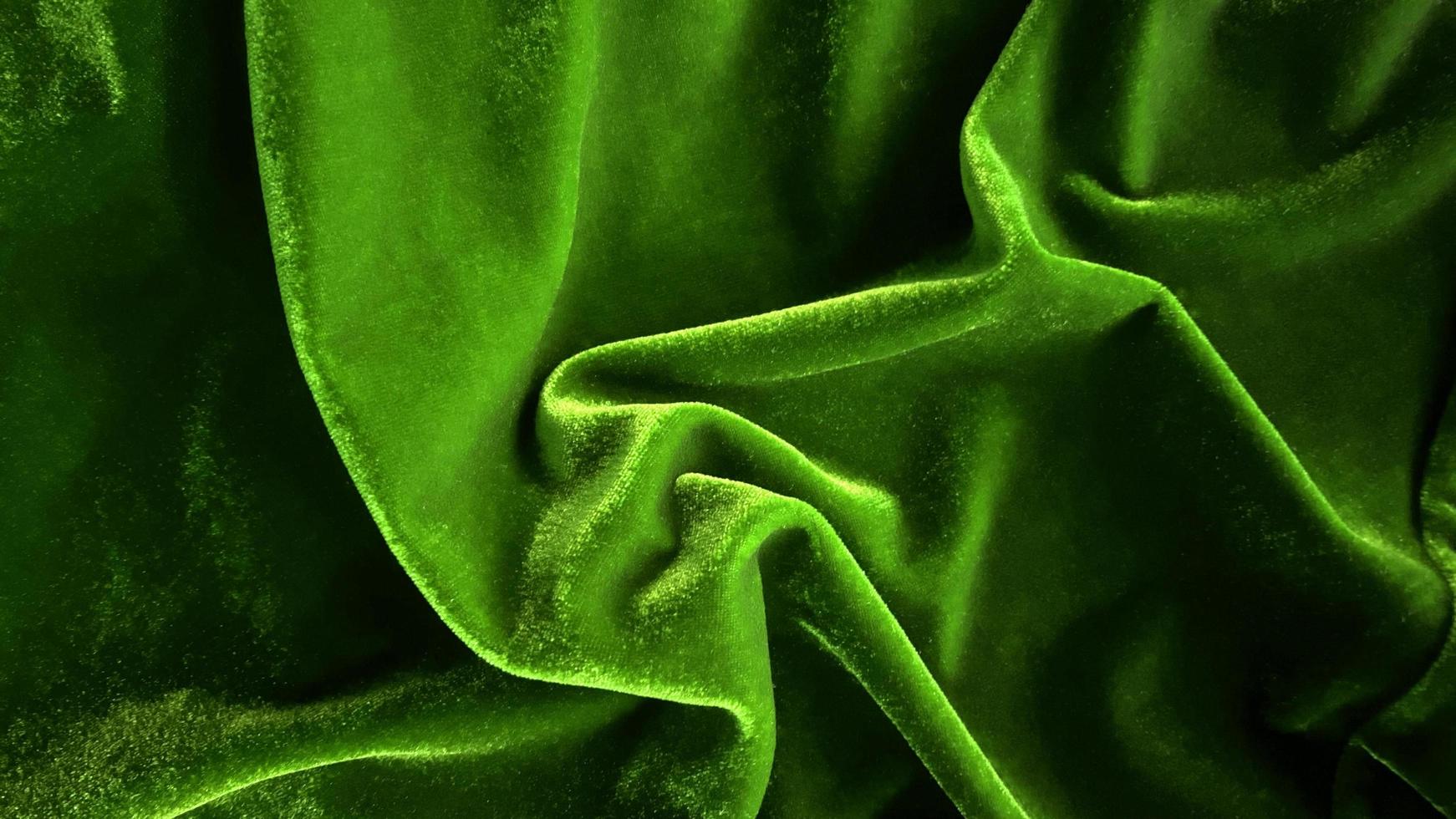 Green velvet fabric texture used as background. Empty green fabric