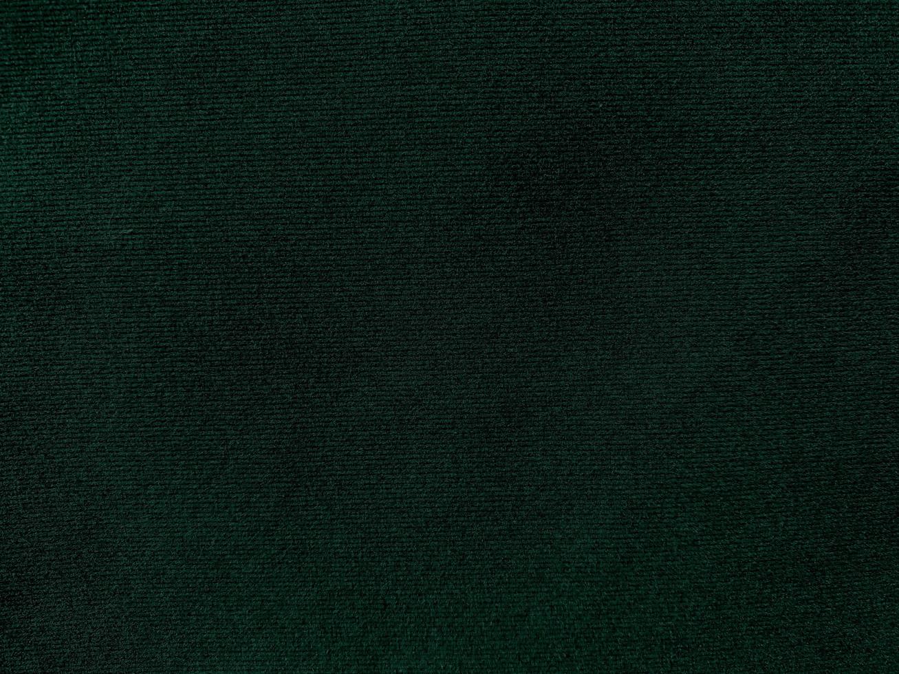 Dark green old velvet fabric texture used as background. Empty green fabric background of soft and smooth textile material. There is space for text. photo