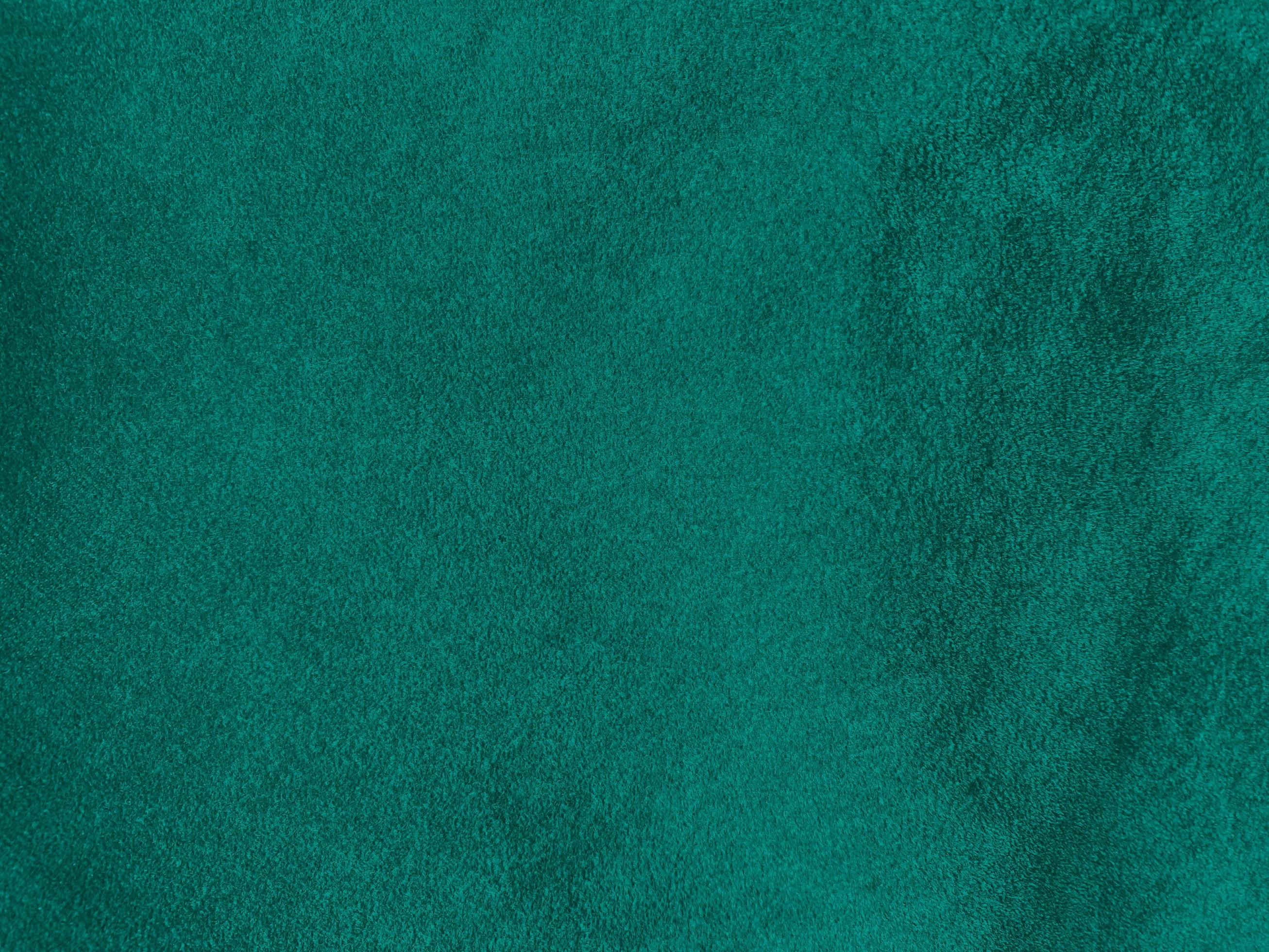 Dark green old velvet fabric texture used as background. Empty green