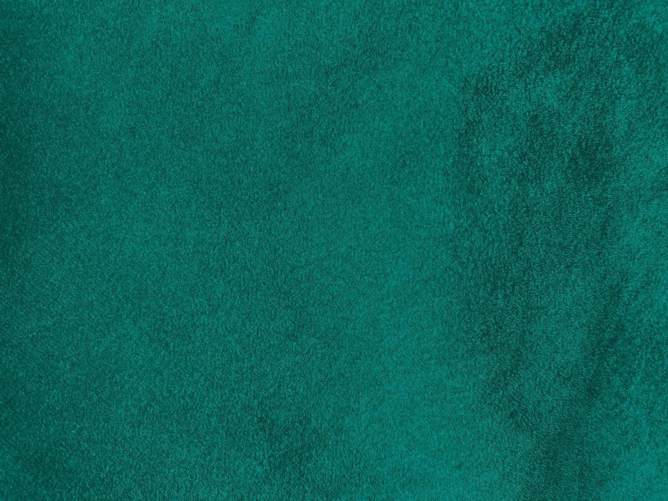 Dark green old velvet fabric texture used as background. Empty green fabric background of soft and smooth textile material. There is space for text.. photo