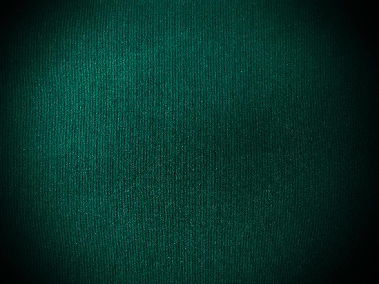 Dark  green velvet fabric texture used as background. Empty green fabric background of soft and smooth textile material. There is space for text. photo