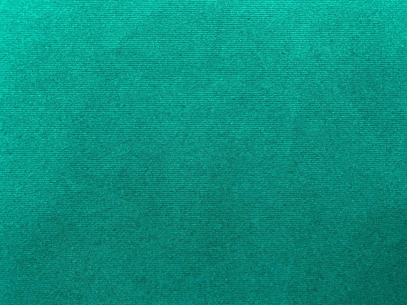 Dark green old velvet fabric texture used as background. Empty green fabric background of soft and smooth textile material. There is space for text.. photo