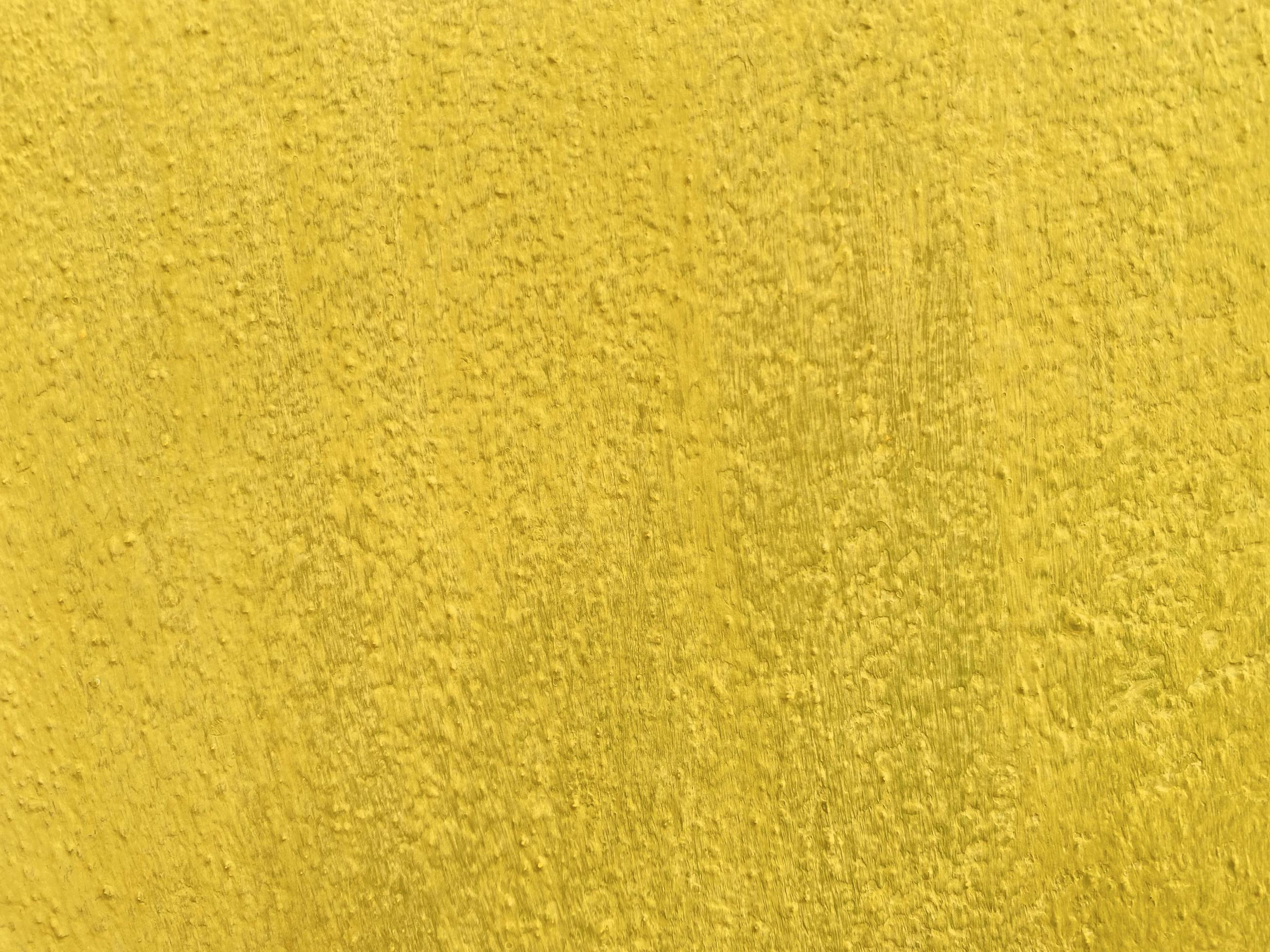 Seamless texture of yellow cement old wall a rough surface, with space