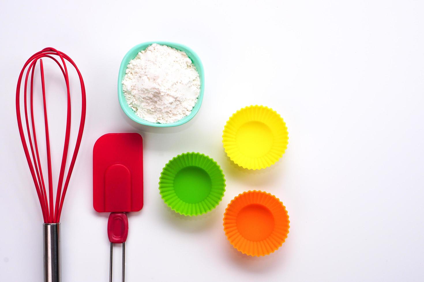 Top view kitchenware wooden rolling pin, wooden spatula and egg beater on white background. photo