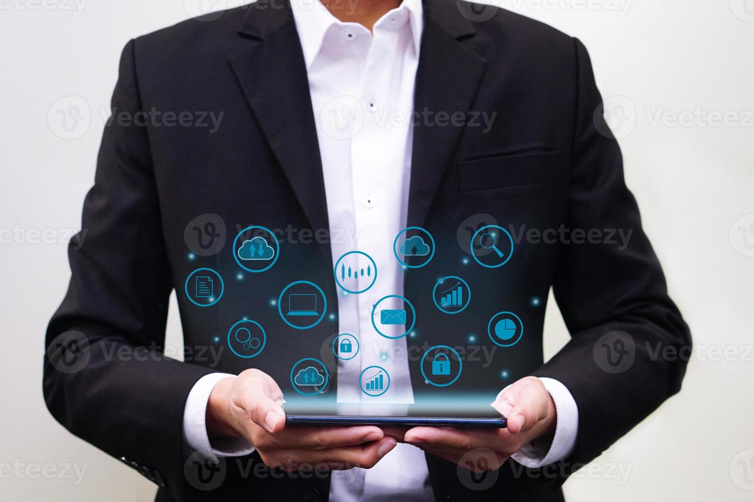 Businessman holding smartphone with multimedia icons virtual. Future technology and business concept. photo