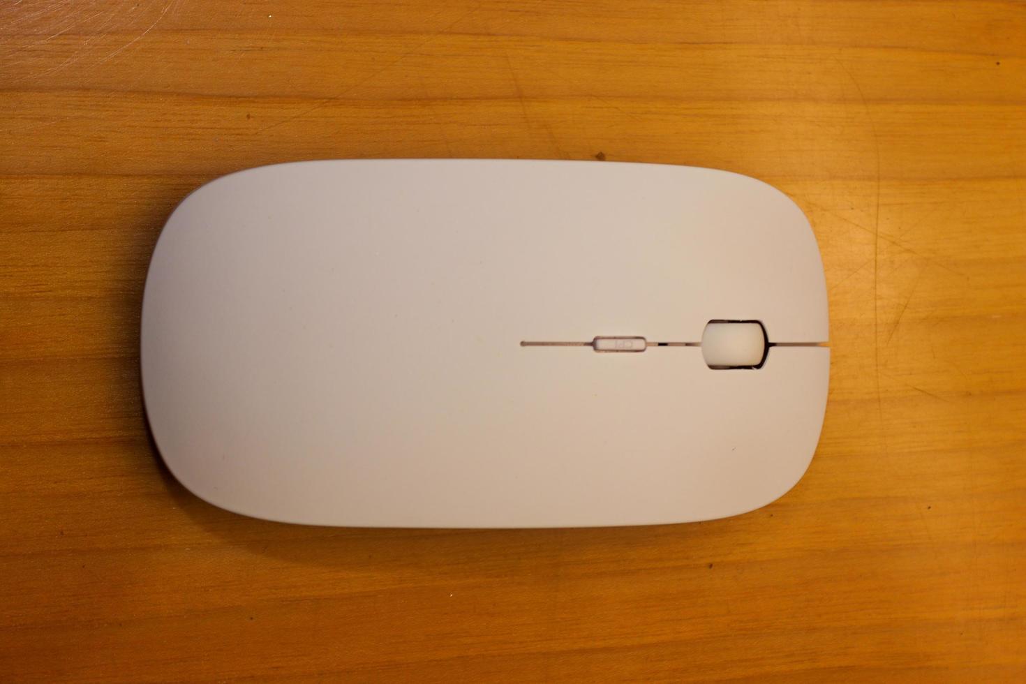 A simple white mouse design illustrated on a woody surface photo