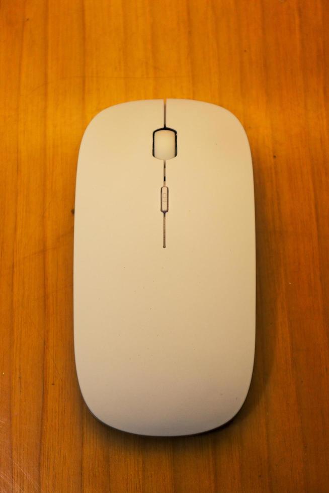 A simple white mouse design illustrated on a woody surface photo