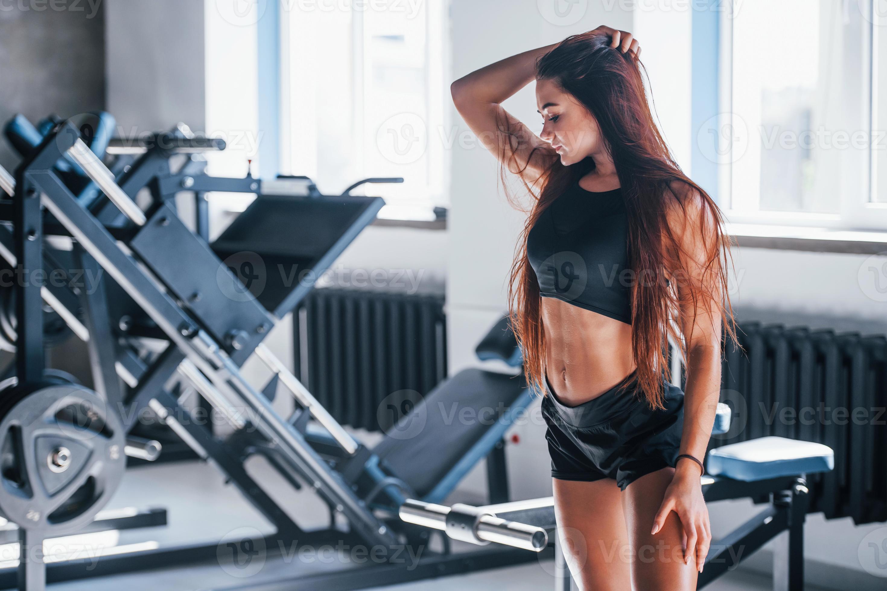 Young fitness woman with slim type of body and in black sportive clothes is  in the gym 15238998 Stock Photo at Vecteezy