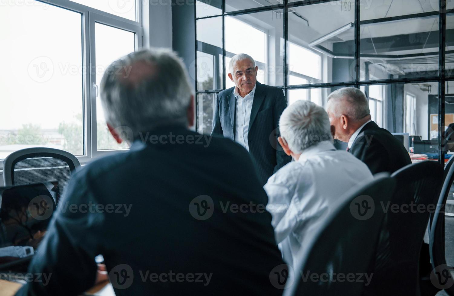 Aged team of elderly businessman architects have a meeting in the office photo