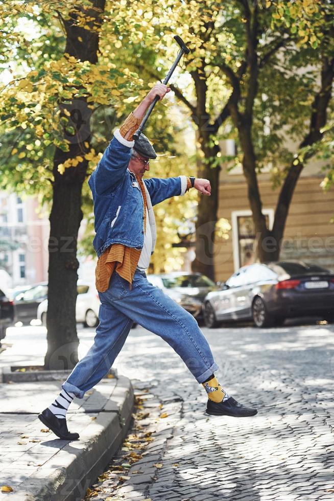 feliz senior con estilo en ropa de moda y en gafas dar un paseo y disfrutar de la vida foto