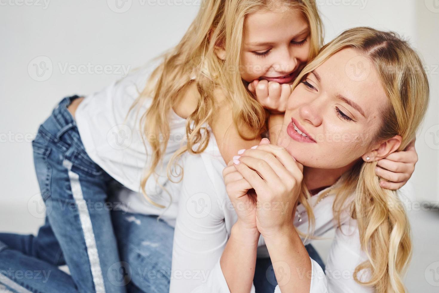 Mother with her daughter together in the studio with white background photo