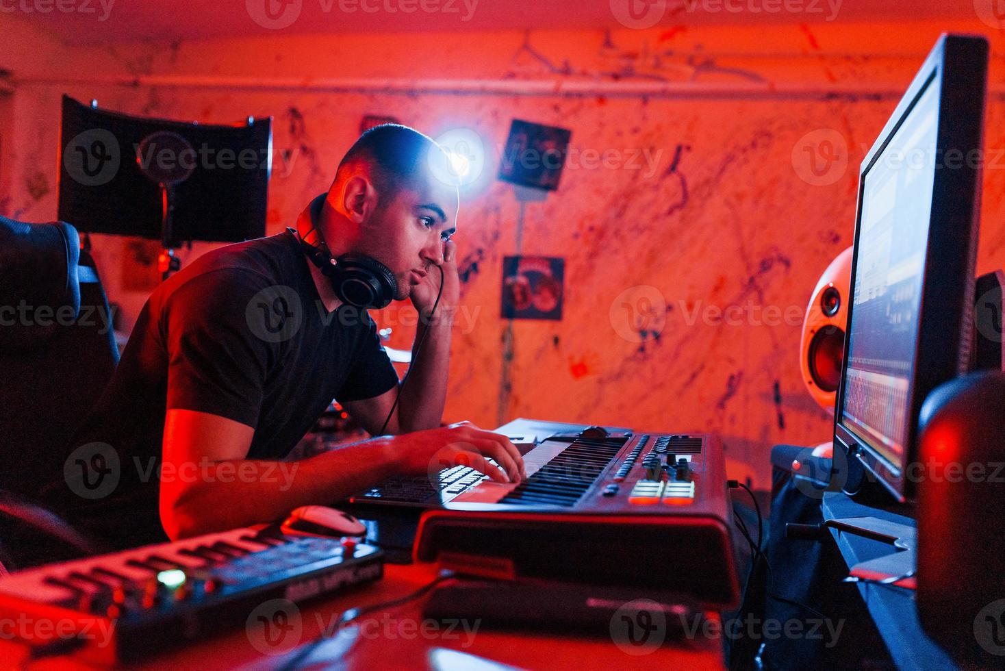 Professional sound engineer working and mixing music indoors in the studio photo