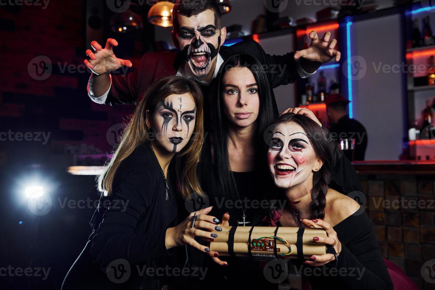 Showing bomb. Friends is on the thematic halloween party in scary makeup and costumes photo