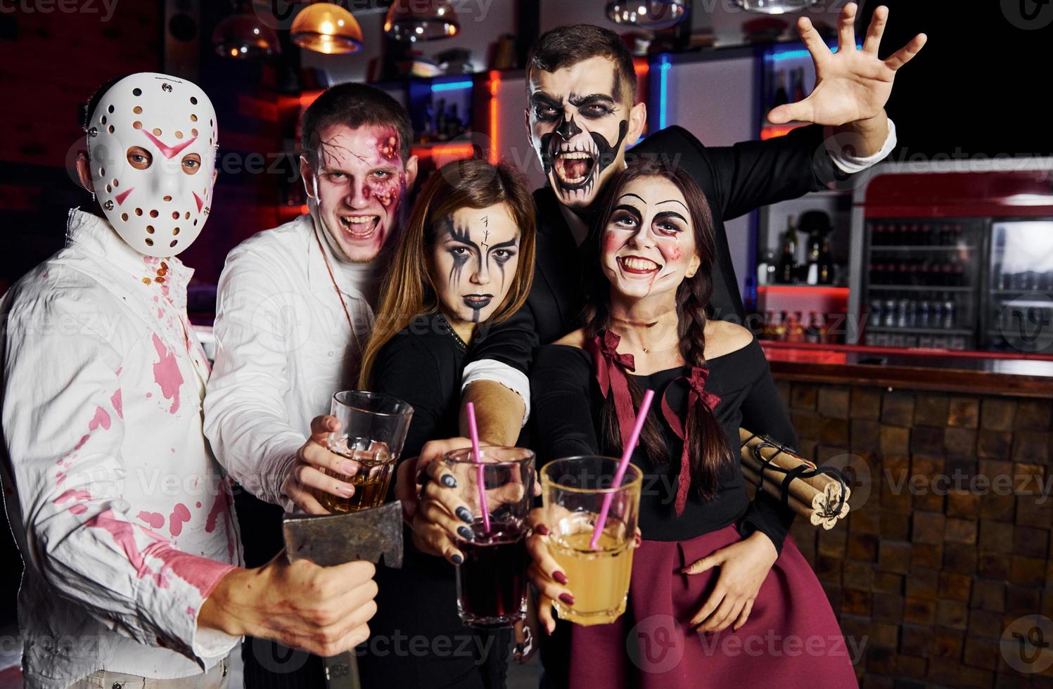 Posing for the camera. Friends is on the thematic halloween party in scary makeup and costumes photo