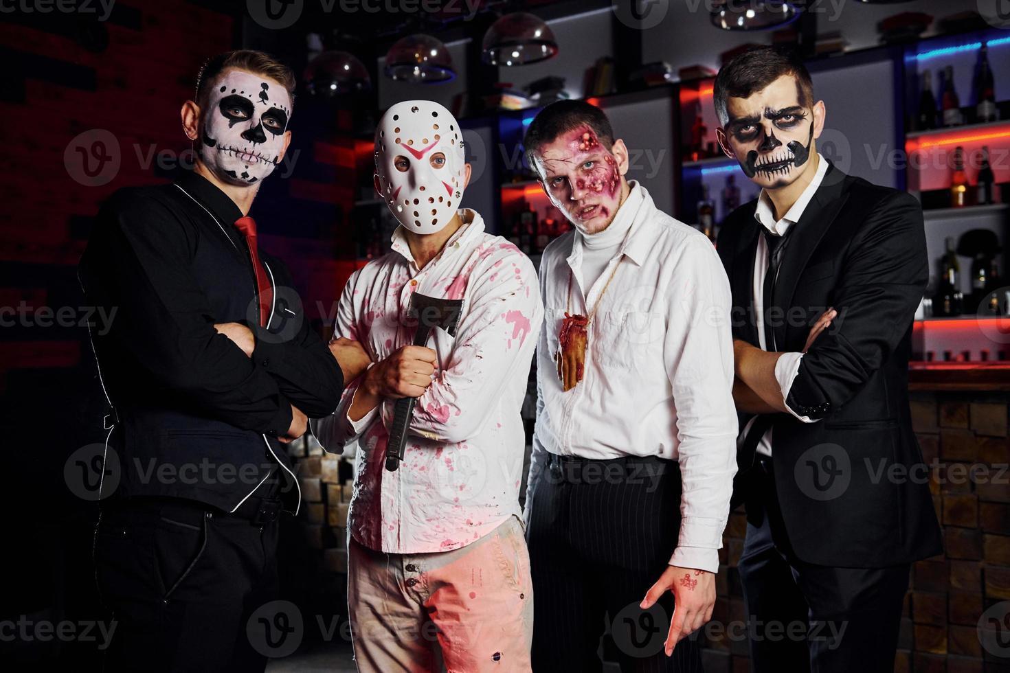 Posing for the camera. Friends is on the thematic halloween party in scary makeup and costumes photo