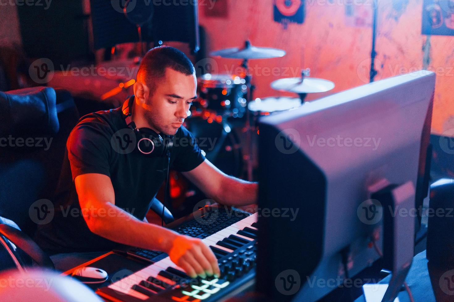 Sound engineer working and mixing music indoors in the studio photo